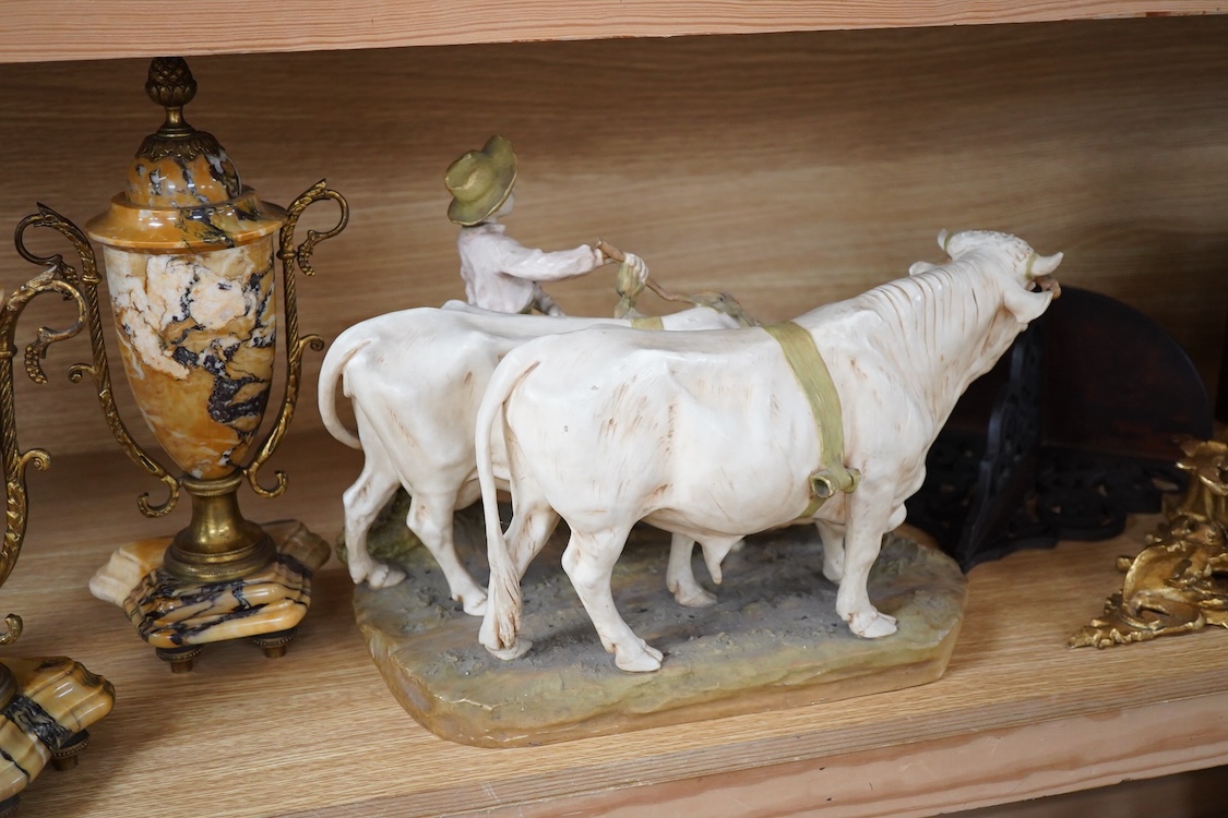 A large Royal Dux porcelain group of a pair oxen with a farm hand, pink triangle mark. 38cm wide
